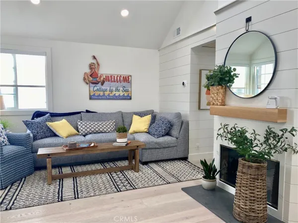 a living room with furniture and a mirror