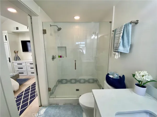 a bathroom with a tub shower sink and toilet