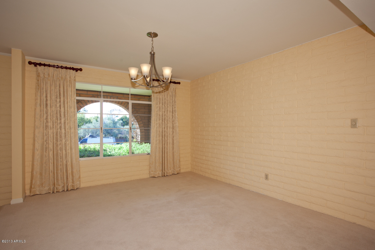 4034 East Rancho Drive Phoenix, AZ 85018 - Photo 11 of 38 en empty room with windows and outdoor view