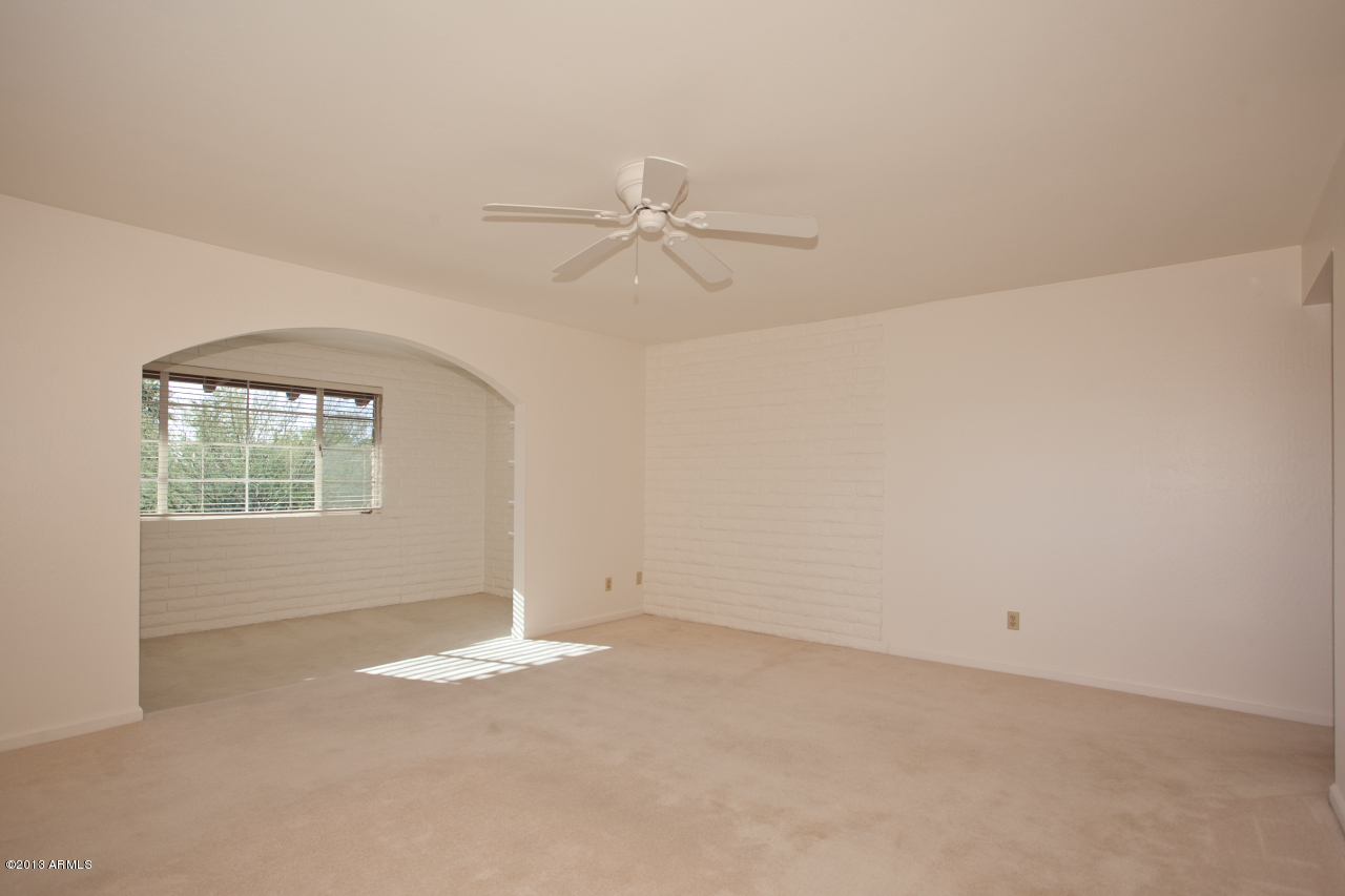 4034 East Rancho Drive Phoenix, AZ 85018 - Photo 20 of 38 an empty room with windows and fan