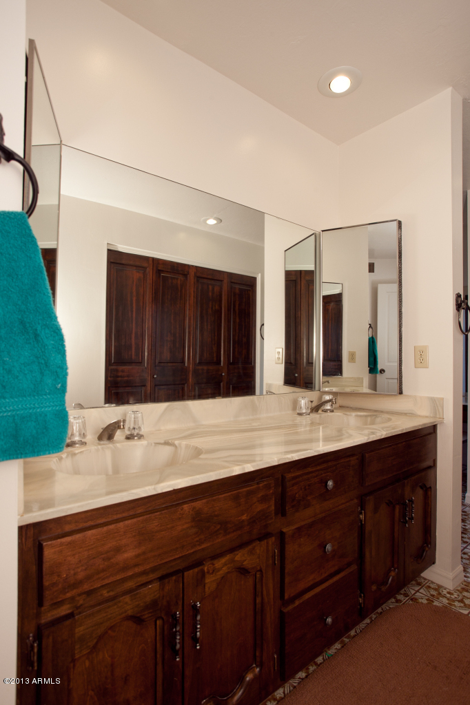 4034 East Rancho Drive Phoenix, AZ 85018 - Photo 21 of 38 a bathroom with a sink and a mirror