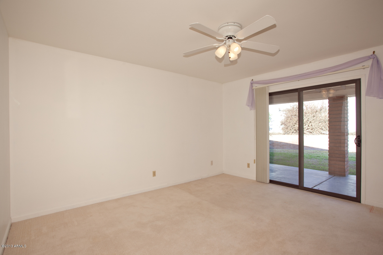 4034 East Rancho Drive Phoenix, AZ 85018 - Photo 24 of 38 an empty room with chandelier fan