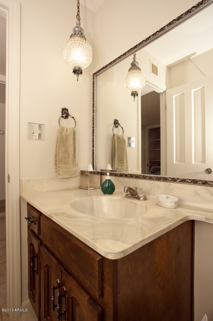 4034 East Rancho Drive Phoenix, AZ 85018 - Photo 26 of 38 a bathroom with a sink and a mirror