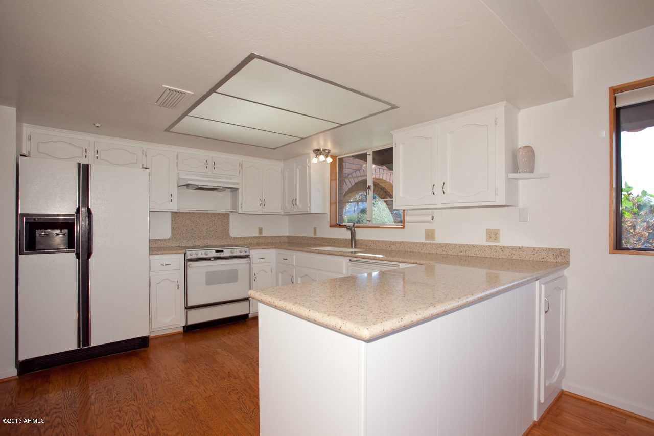 4034 East Rancho Drive Phoenix, AZ 85018 - Photo 27 of 38 a kitchen with stainless steel appliances granite countertop a sink stove and refrigerator