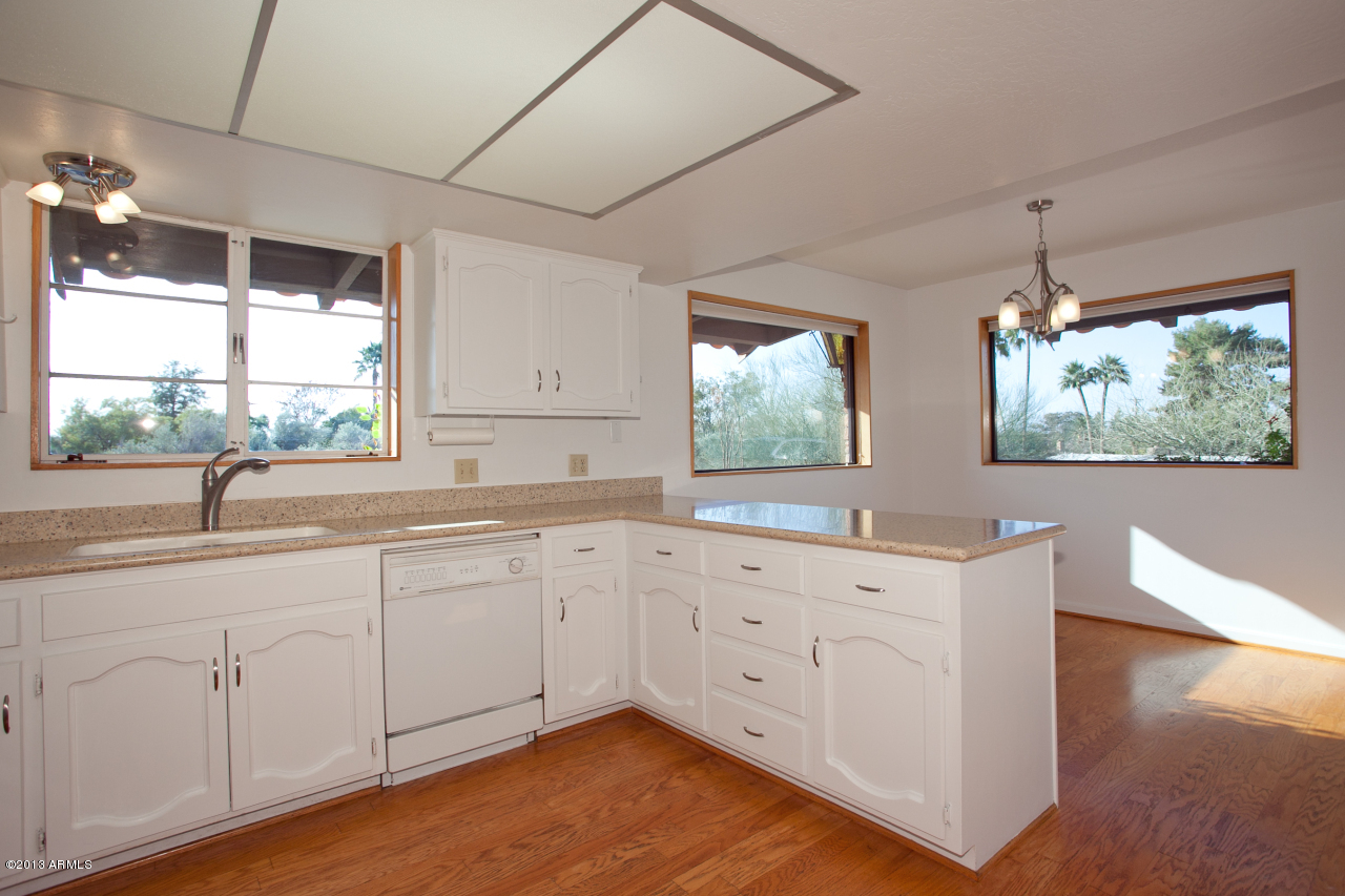 4034 East Rancho Drive Phoenix, AZ 85018 - Photo 28 of 38 a kitchen with sink cabinets and window