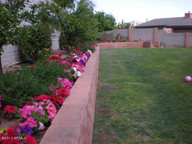 4034 East Rancho Drive Phoenix, AZ 85018 - Photo 32 of 38 a front view of a house with a yard and fountain