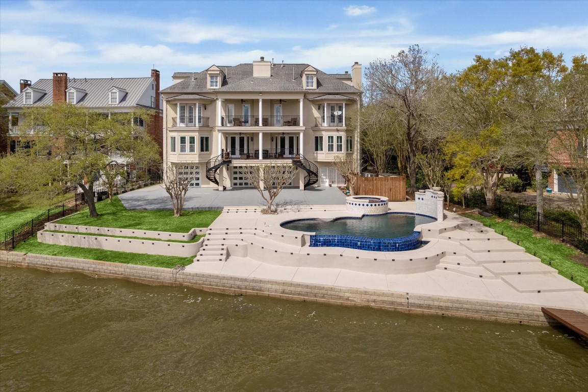 a view of a house with pool and sitting area