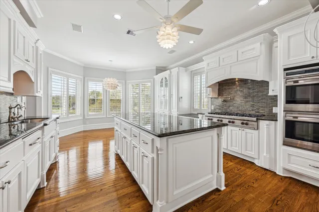 a kitchen with granite countertop stainless steel appliances and cabinets
