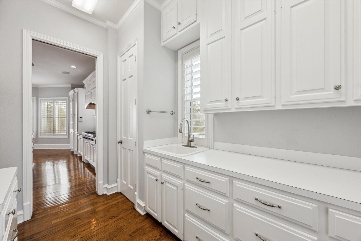 1406 Spring Cress Lane Seabrook, TX 77586 - Photo 17 of 50 a kitchen with white cabinets and sink