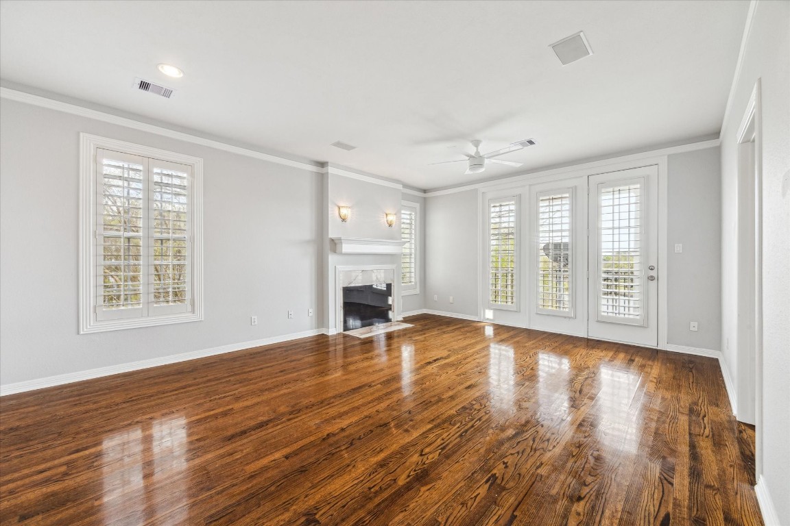 1406 Spring Cress Lane Seabrook, TX 77586 - Photo 18 of 50 a view of empty room with wooden floor and fireplace