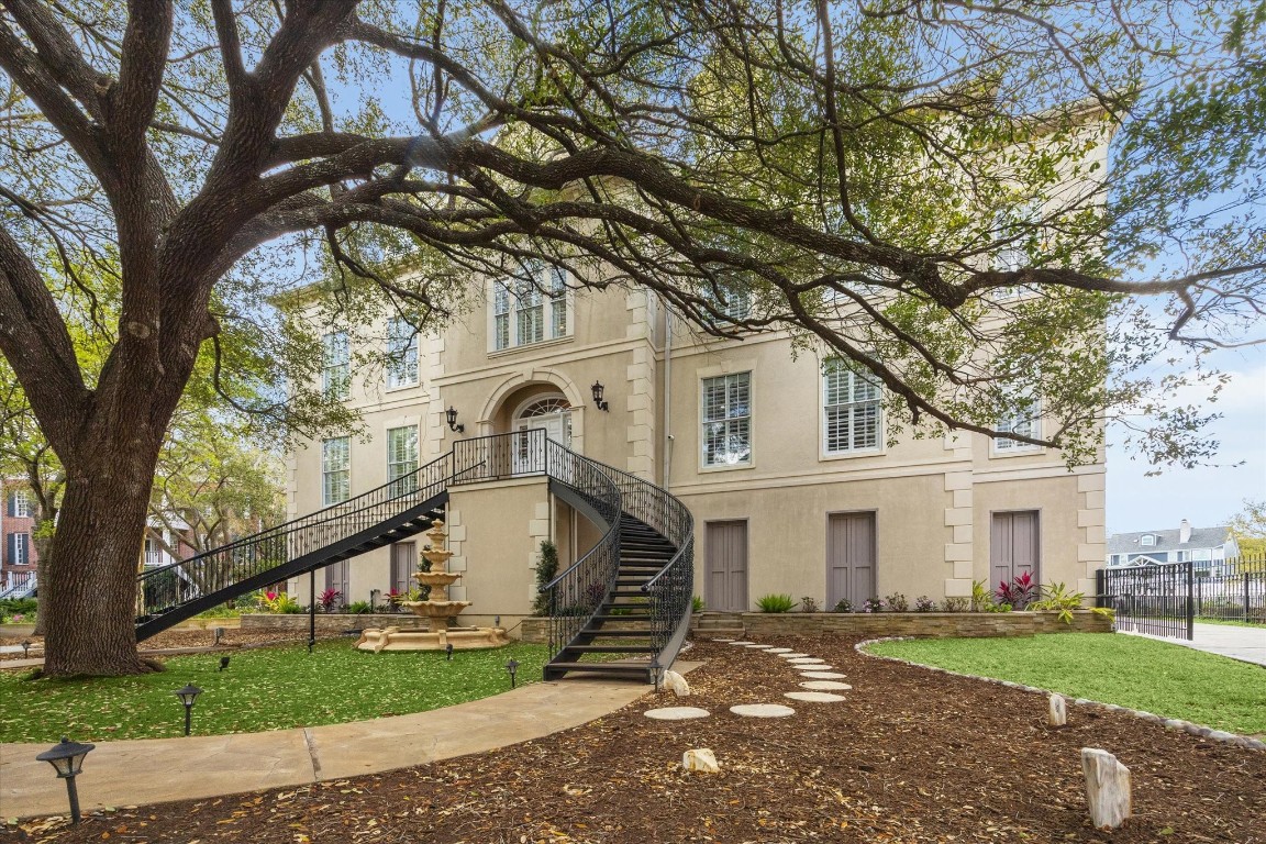 1406 Spring Cress Lane Seabrook, TX 77586 - Photo 2 of 50 a view of a white house with a large tree and a yard