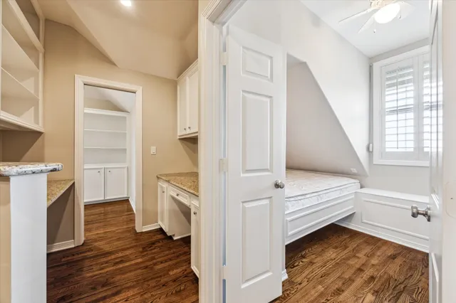a bathroom with a granite countertop sink a toilet and shower