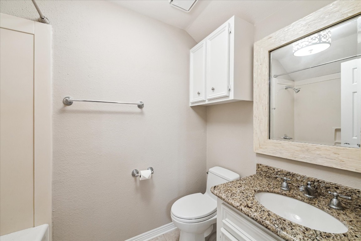 1406 Spring Cress Lane Seabrook, TX 77586 - Photo 36 of 50 a bathroom with a granite countertop sink a toilet and shower
