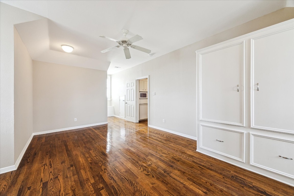 1406 Spring Cress Lane Seabrook, TX 77586 - Photo 37 of 50 an empty room with wooden floor cabinet and windows