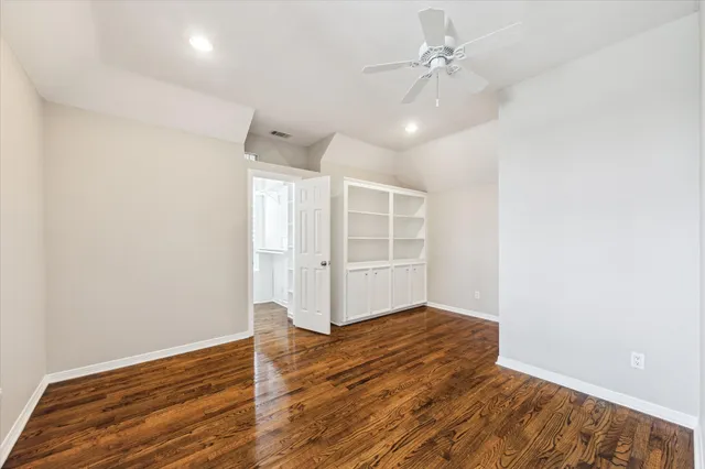 a view of a big room with windows and chandelier
