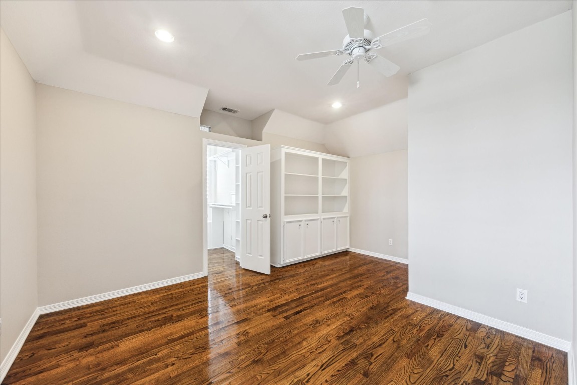 1406 Spring Cress Lane Seabrook, TX 77586 - Photo 38 of 50 an empty room with wooden floor ceiling fan and windows