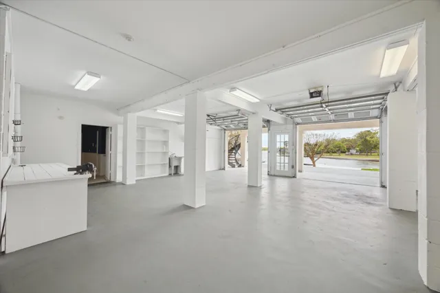 a view of an empty room with window and cabinet