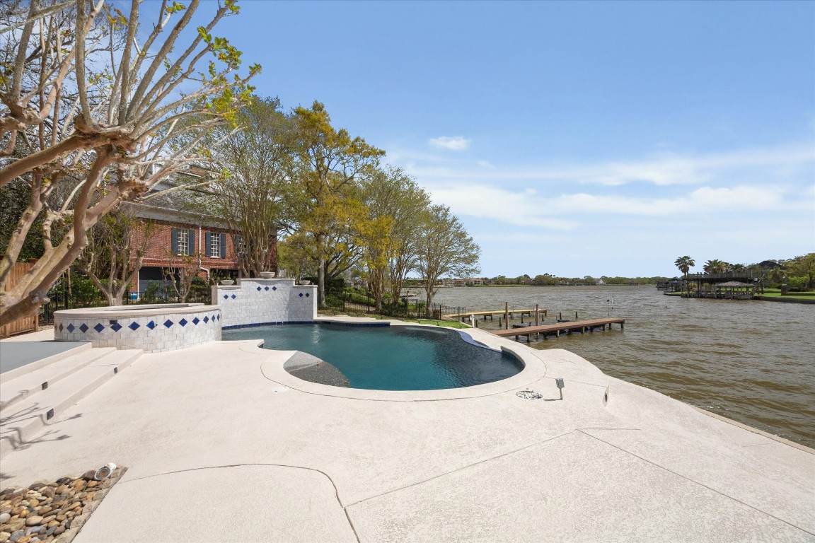 1406 Spring Cress Lane Seabrook, TX 77586 - Photo 43 of 50 a view of a swimming pool with a patio and a yard