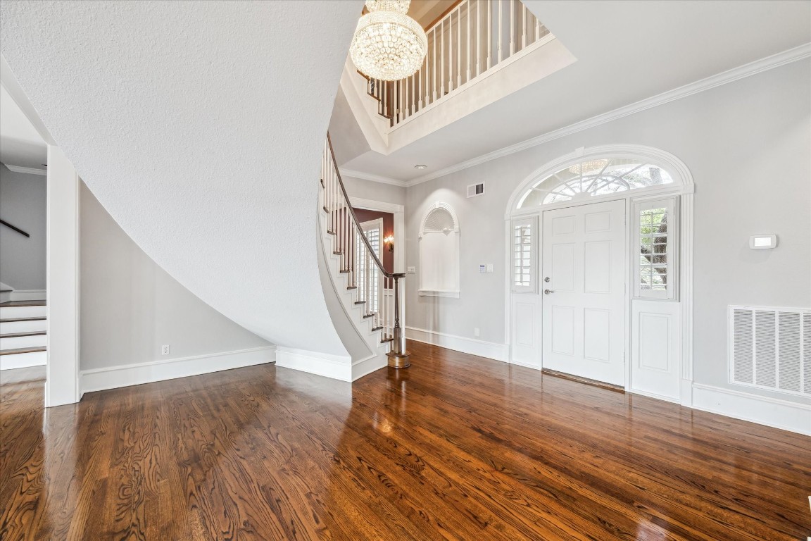 1406 Spring Cress Lane Seabrook, TX 77586 - Photo 7 of 50 a view of a hallway view with wooden floor and staircase