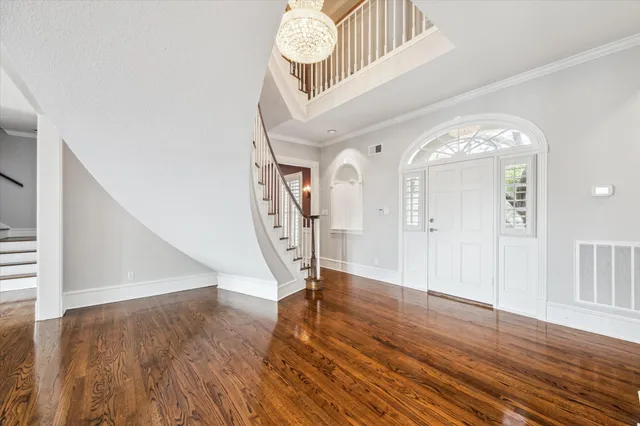 a view of empty room with wooden floor and fireplace
