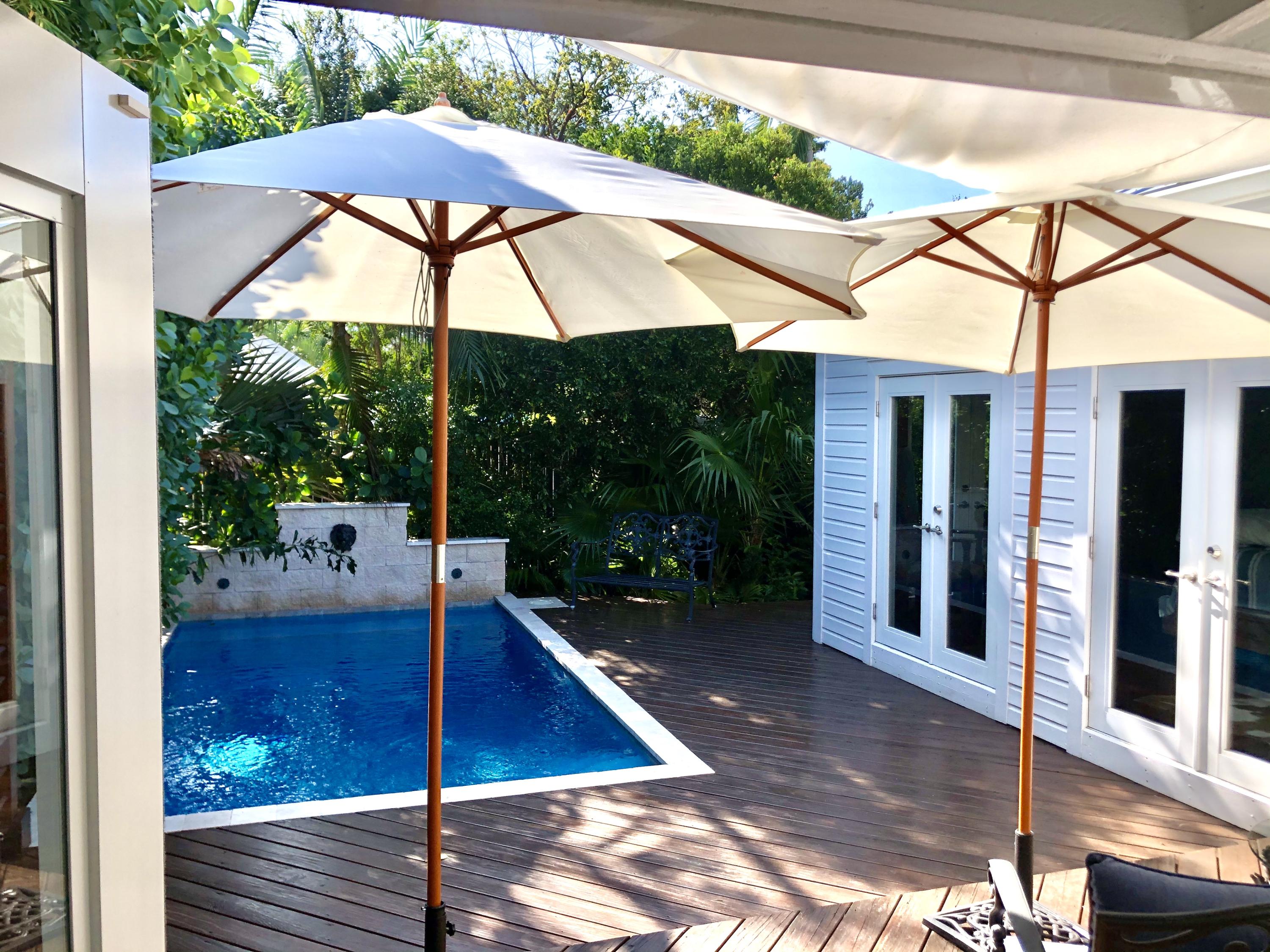 1118 Pearl Street Key West, FL 33040 - Photo 3 of 7 a view of patio with a table and chairs under an umbrella