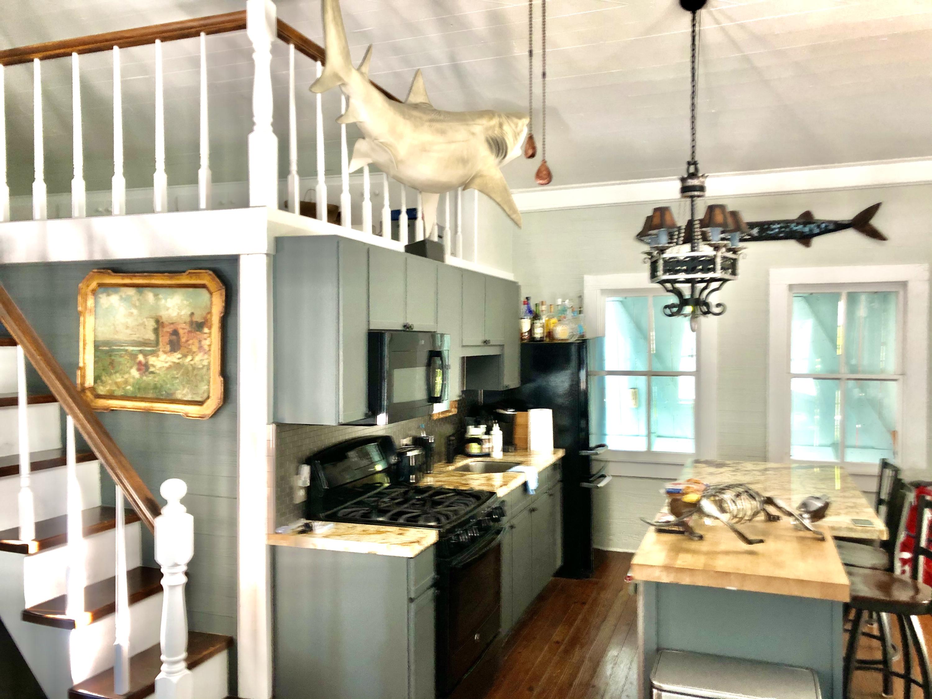 1118 Pearl Street Key West, FL 33040 - Photo 5 of 7 a kitchen with furniture a stove and a window