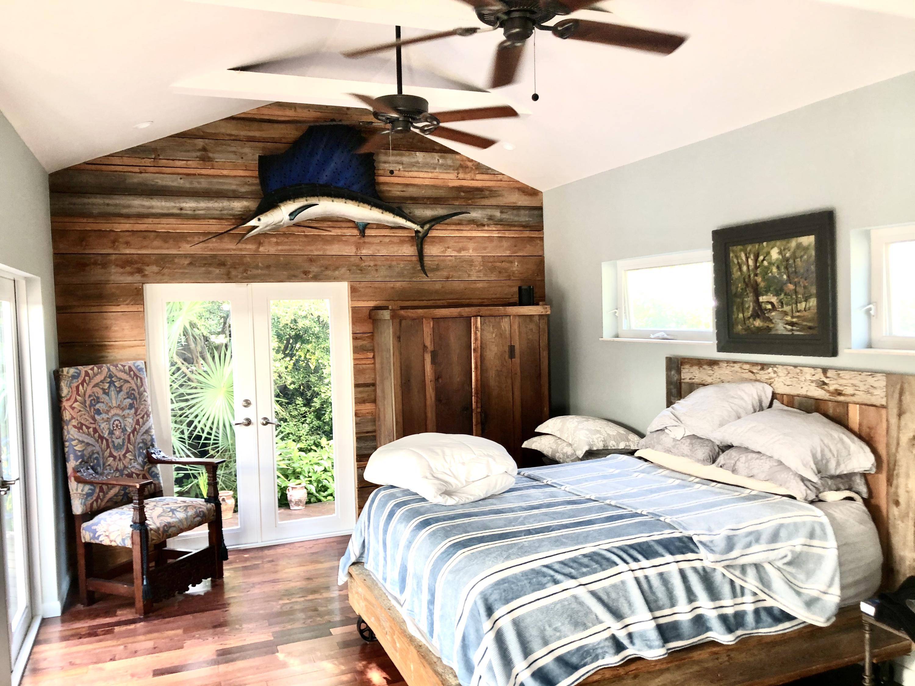 1118 Pearl Street Key West, FL 33040 - Photo 6 of 7 a bedroom with a bed window and couch