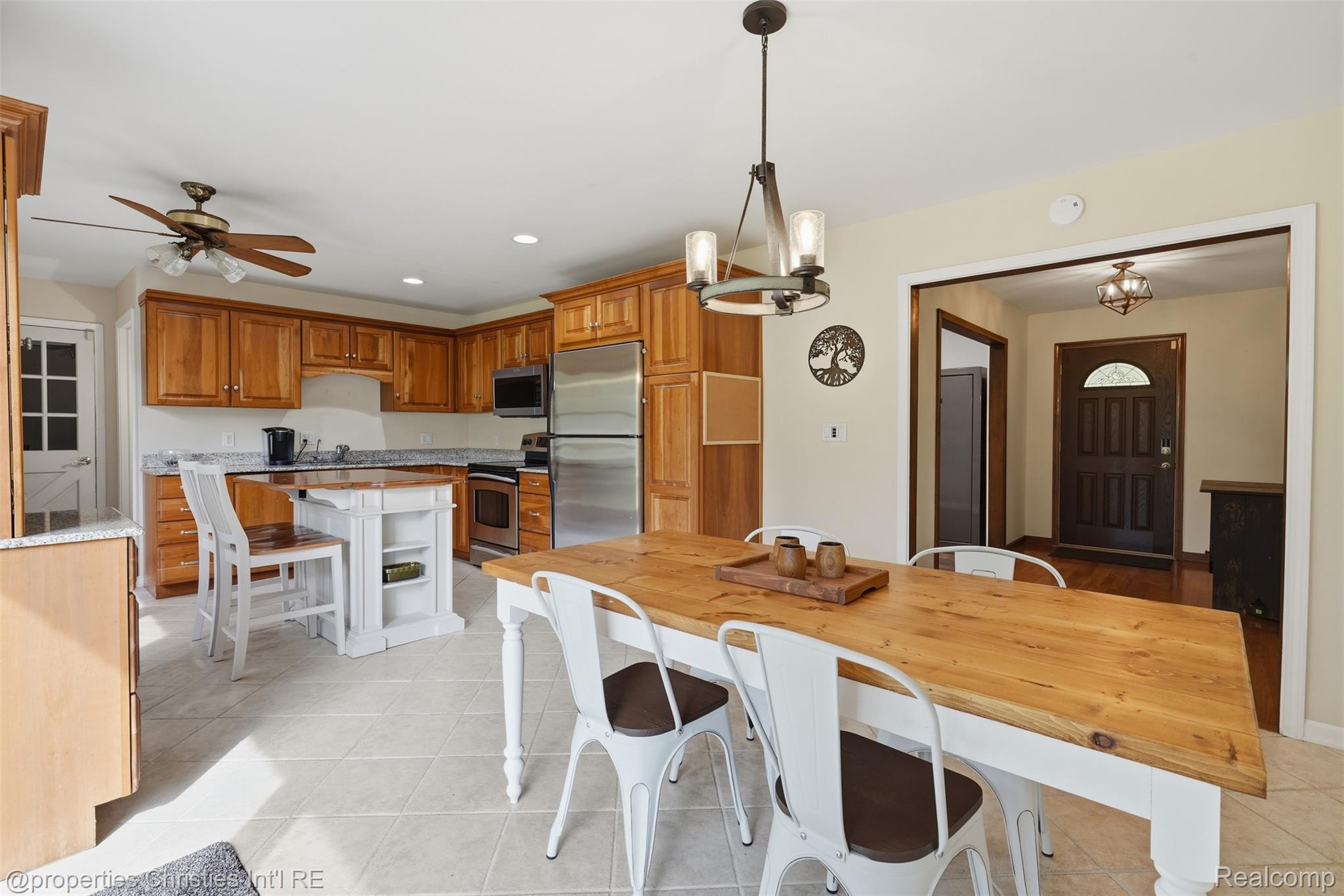 4030 Textile Road Ypsilanti, MI 48197 - Photo 11 of 58 Kitchen featuring wood-finish cabinetry, stainless steel appliances, a center island with built-in storage, and tile flooring