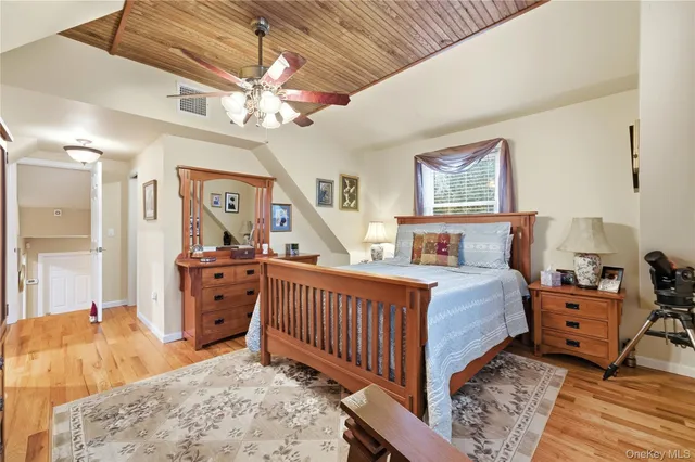 a bedroom with furniture and a dresser