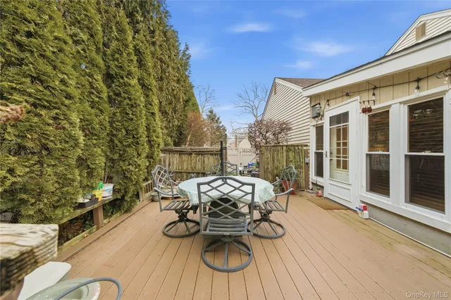 a view of a patio with couches table and chairs and potted plants