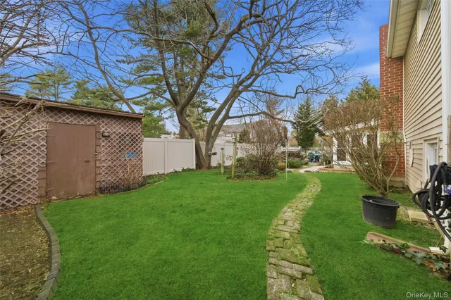 a view of a backyard with large tree