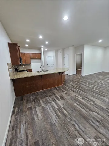 a spacious bathroom with a granite countertop sink and dish washer