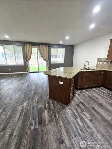 a kitchen with stainless steel appliances granite countertop a sink and cabinets