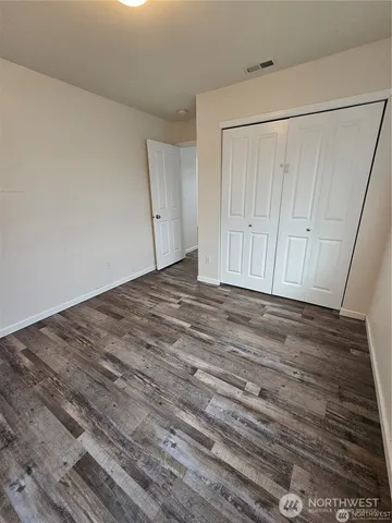 a view of a backyard with chairs and a patio