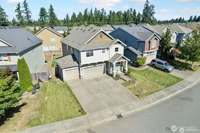 an aerial view of residential houses with outdoor space and trees