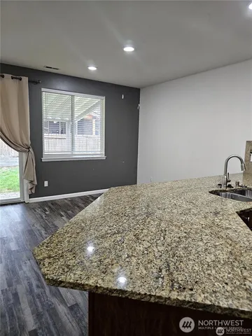 a kitchen with stainless steel appliances granite countertop a stove and a refrigerator