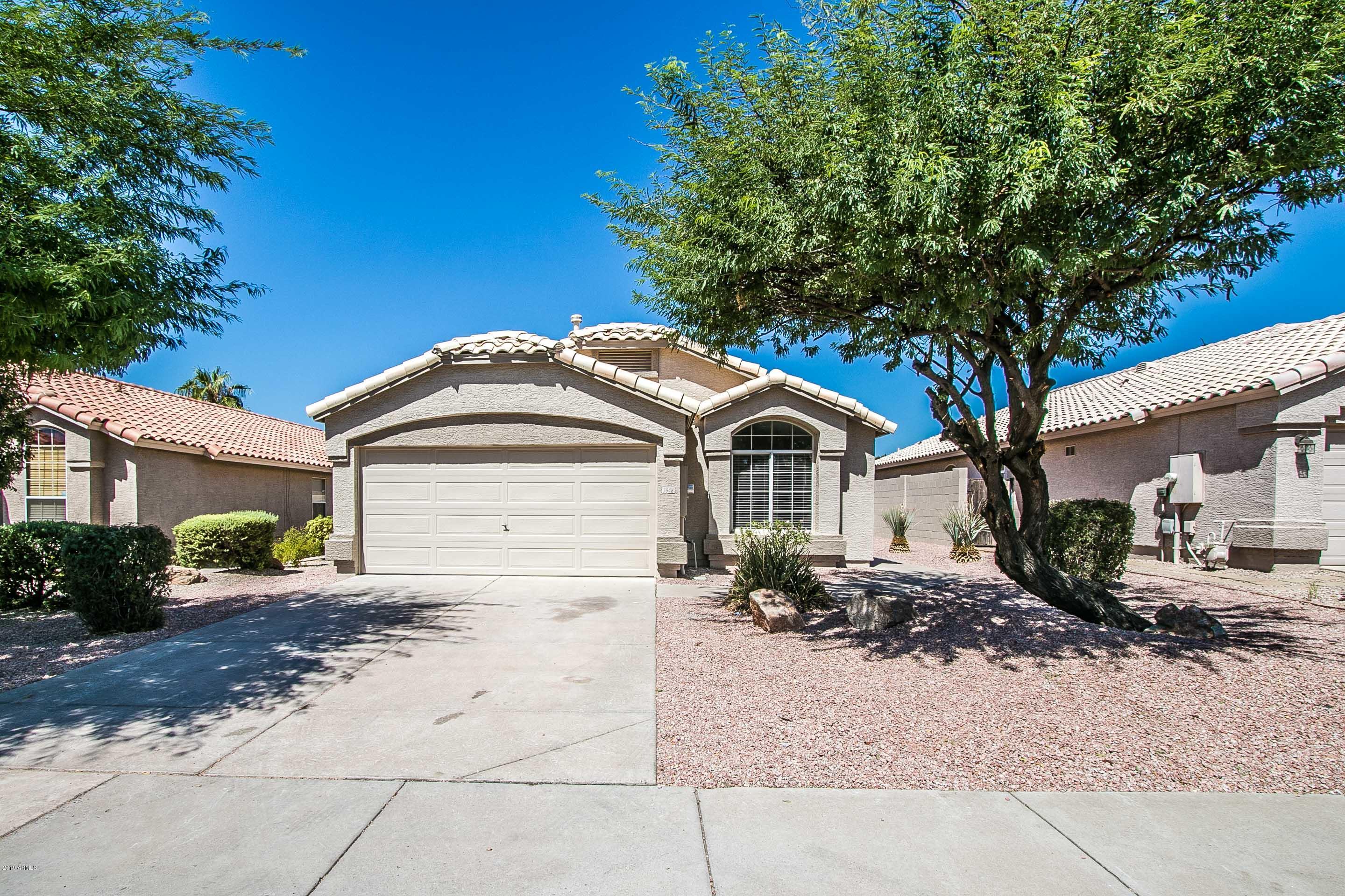 3948 East Stanford Avenue Gilbert, AZ 85234 - Photo 1 of 32 a front view of a house with a yard