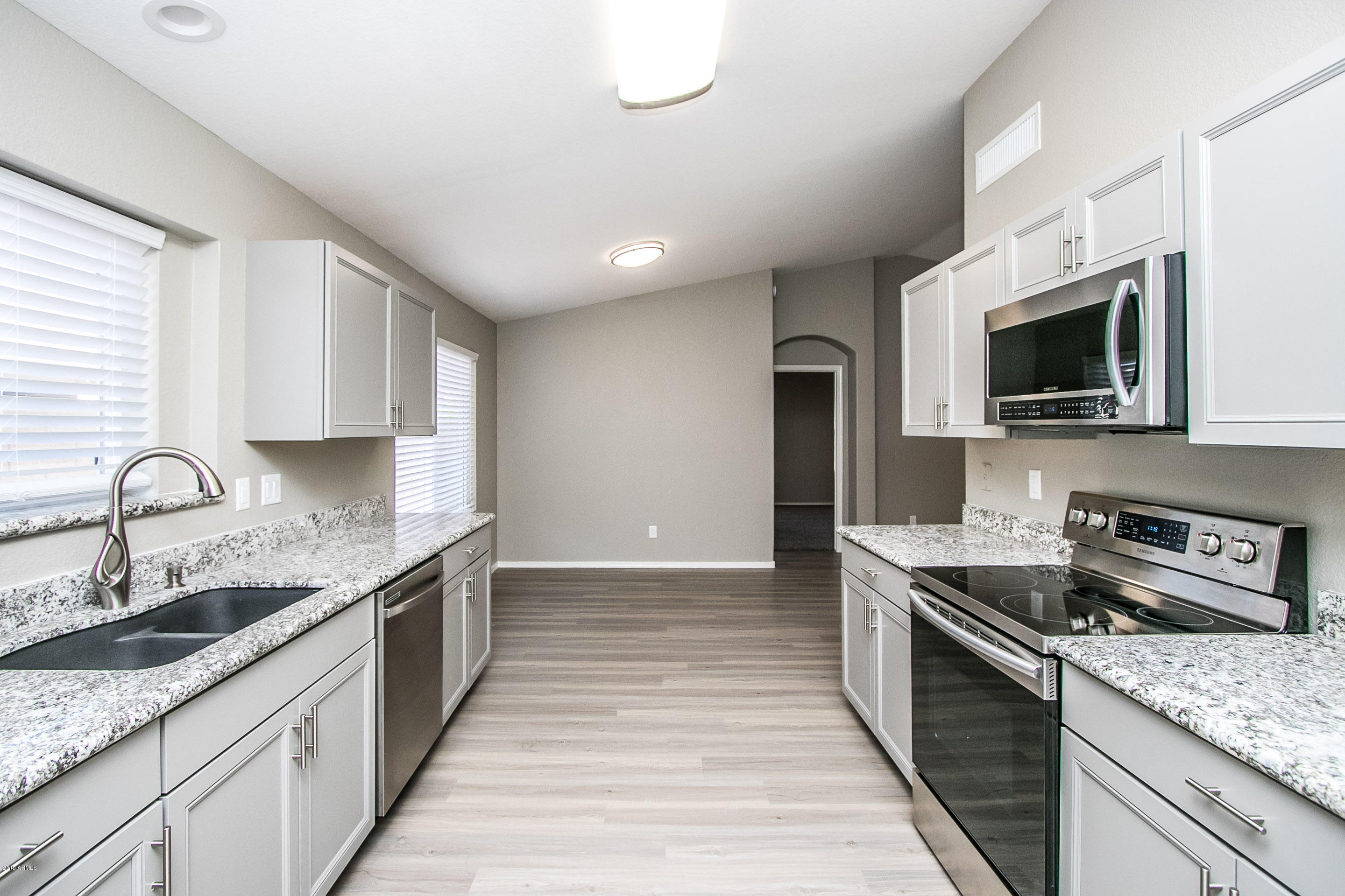 3948 East Stanford Avenue Gilbert, AZ 85234 - Photo 11 of 32 a kitchen with a sink stove top oven and refrigerator