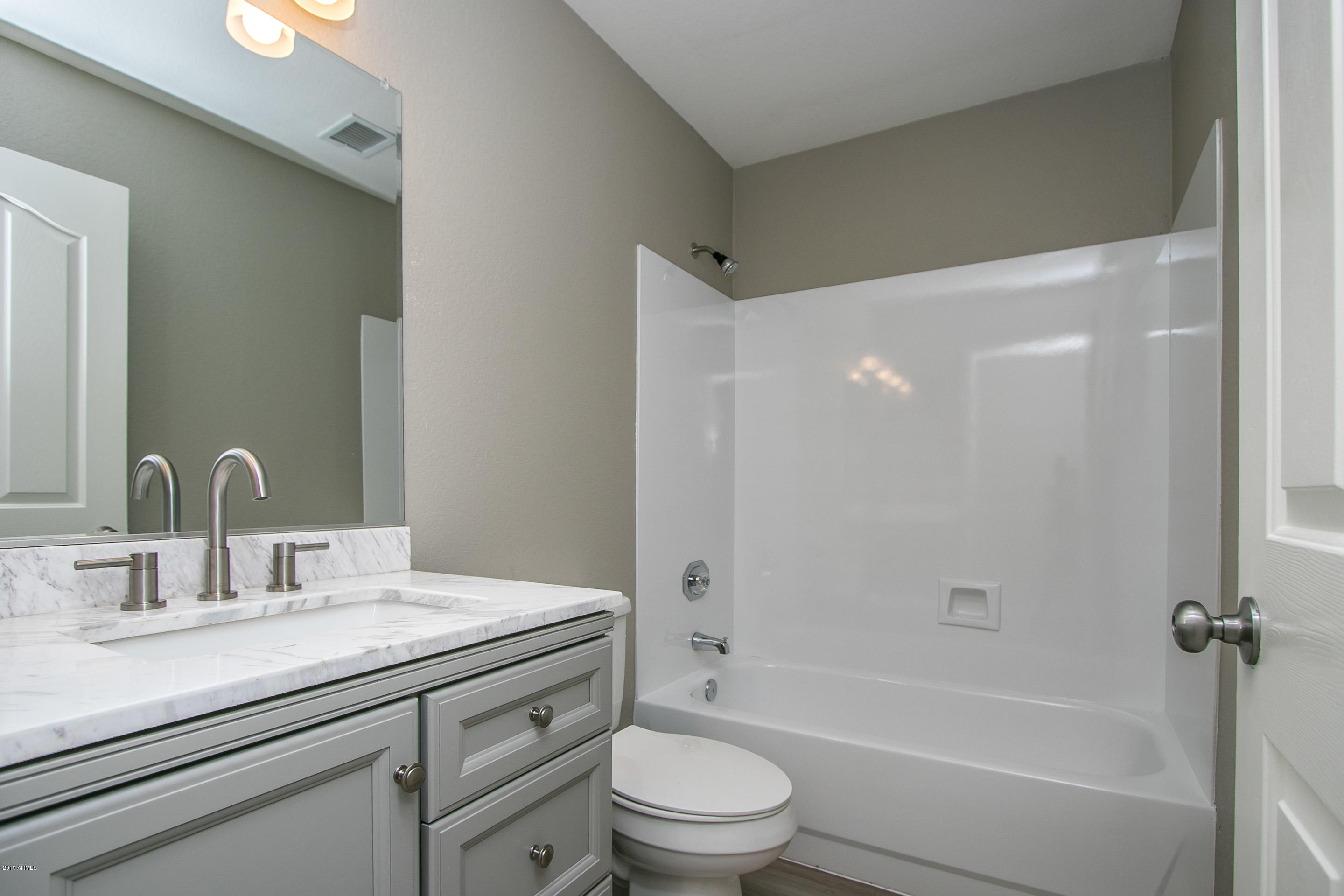 3948 East Stanford Avenue Gilbert, AZ 85234 - Photo 13 of 32 a bathroom with a granite countertop sink a toilet and shower
