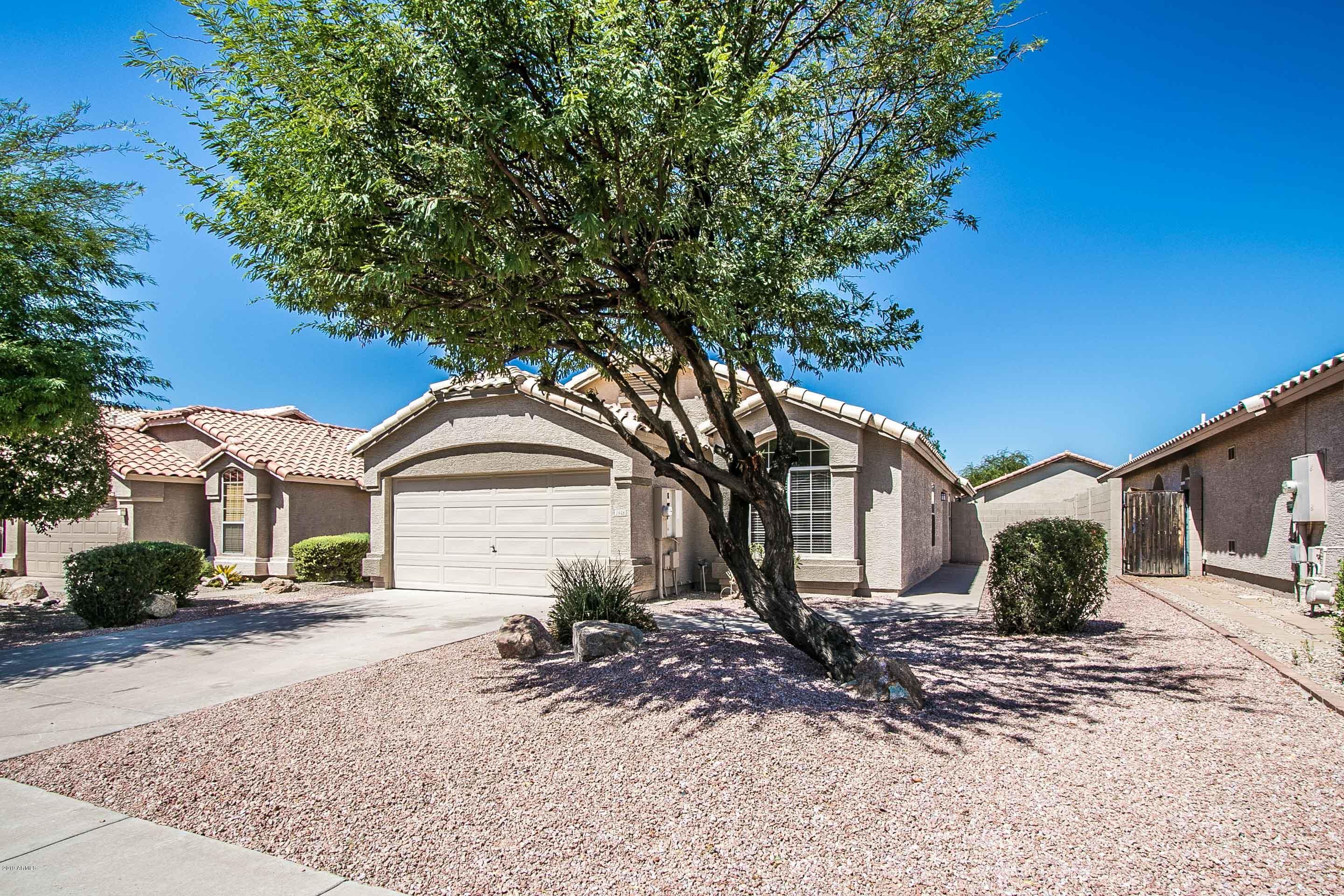 3948 East Stanford Avenue Gilbert, AZ 85234 - Photo 2 of 32 a front view of a house with garden