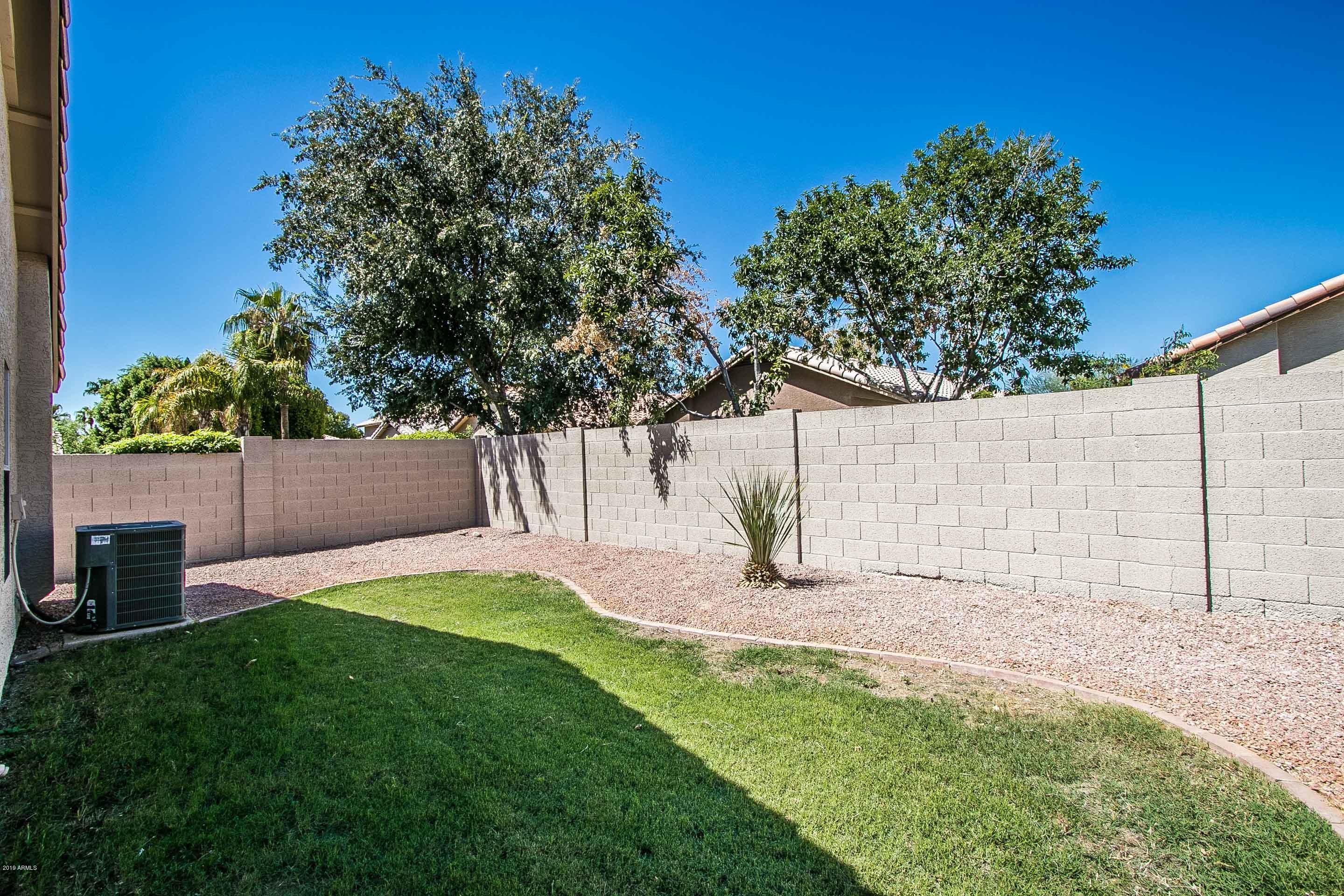 3948 East Stanford Avenue Gilbert, AZ 85234 - Photo 29 of 32 a view of a backyard with a tree