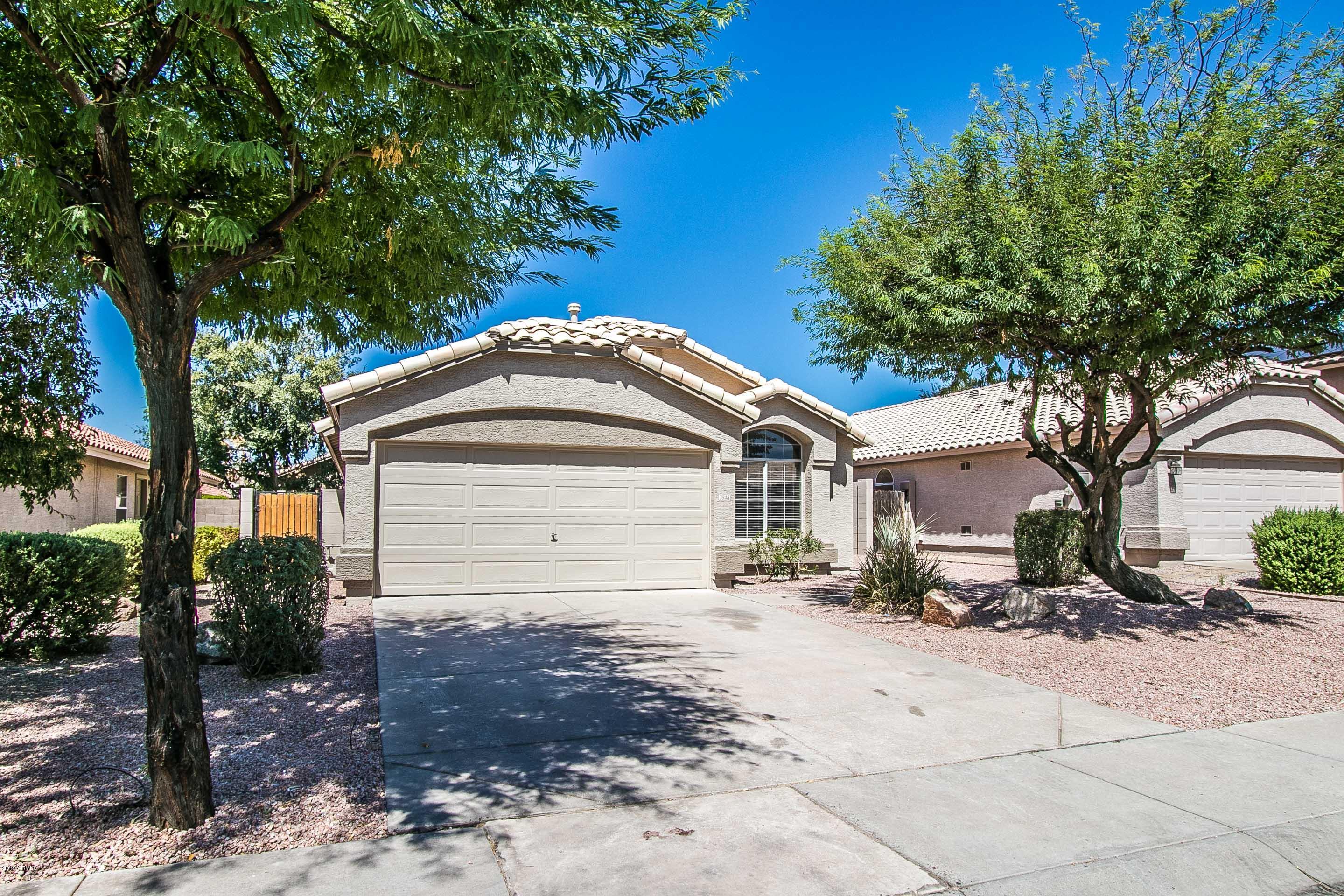 3948 East Stanford Avenue Gilbert, AZ 85234 - Photo 3 of 32 a front view of a house with a garden