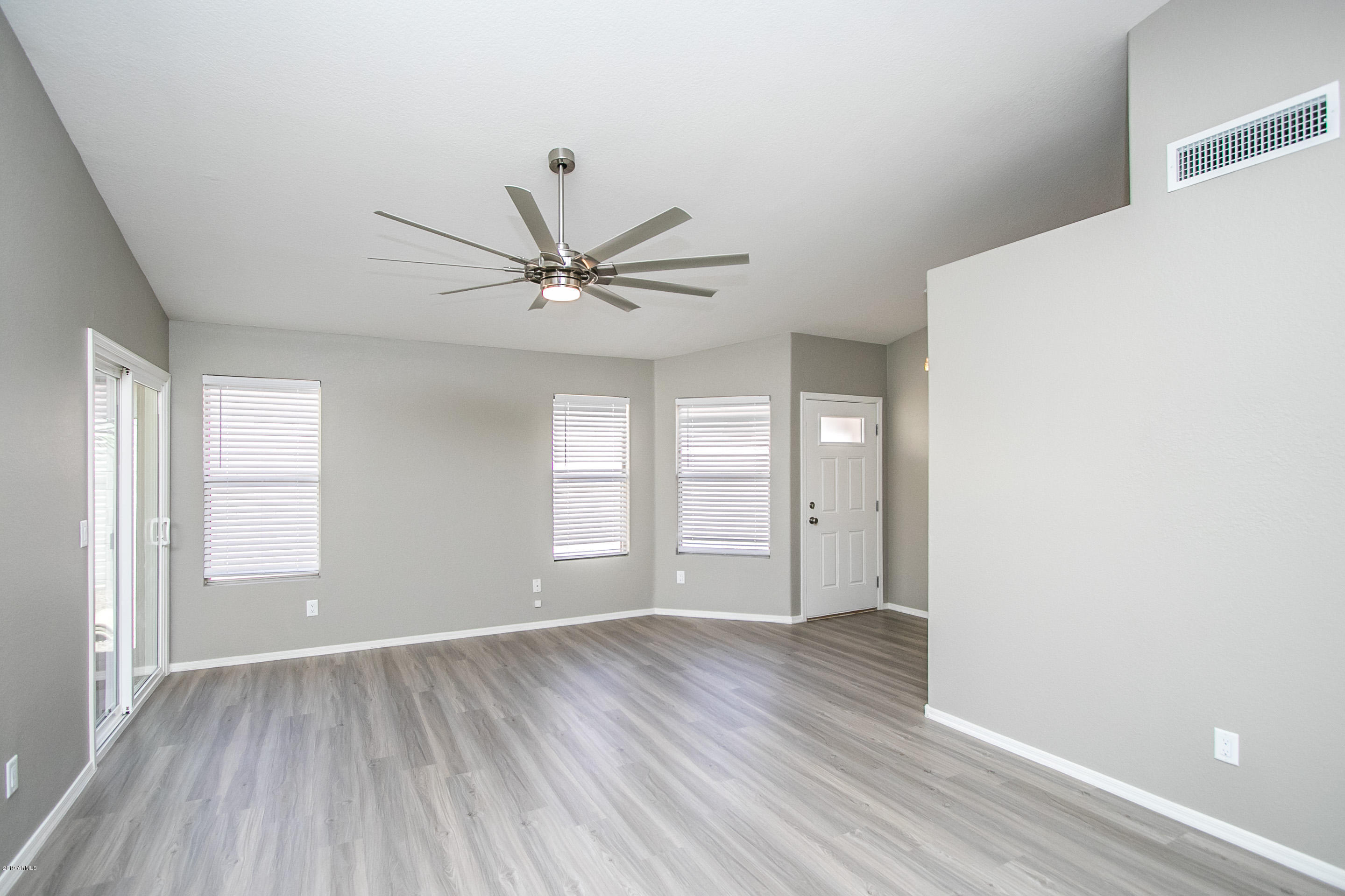 3948 East Stanford Avenue Gilbert, AZ 85234 - Photo 4 of 32 a view of a big room with wooden floor and windows in a room