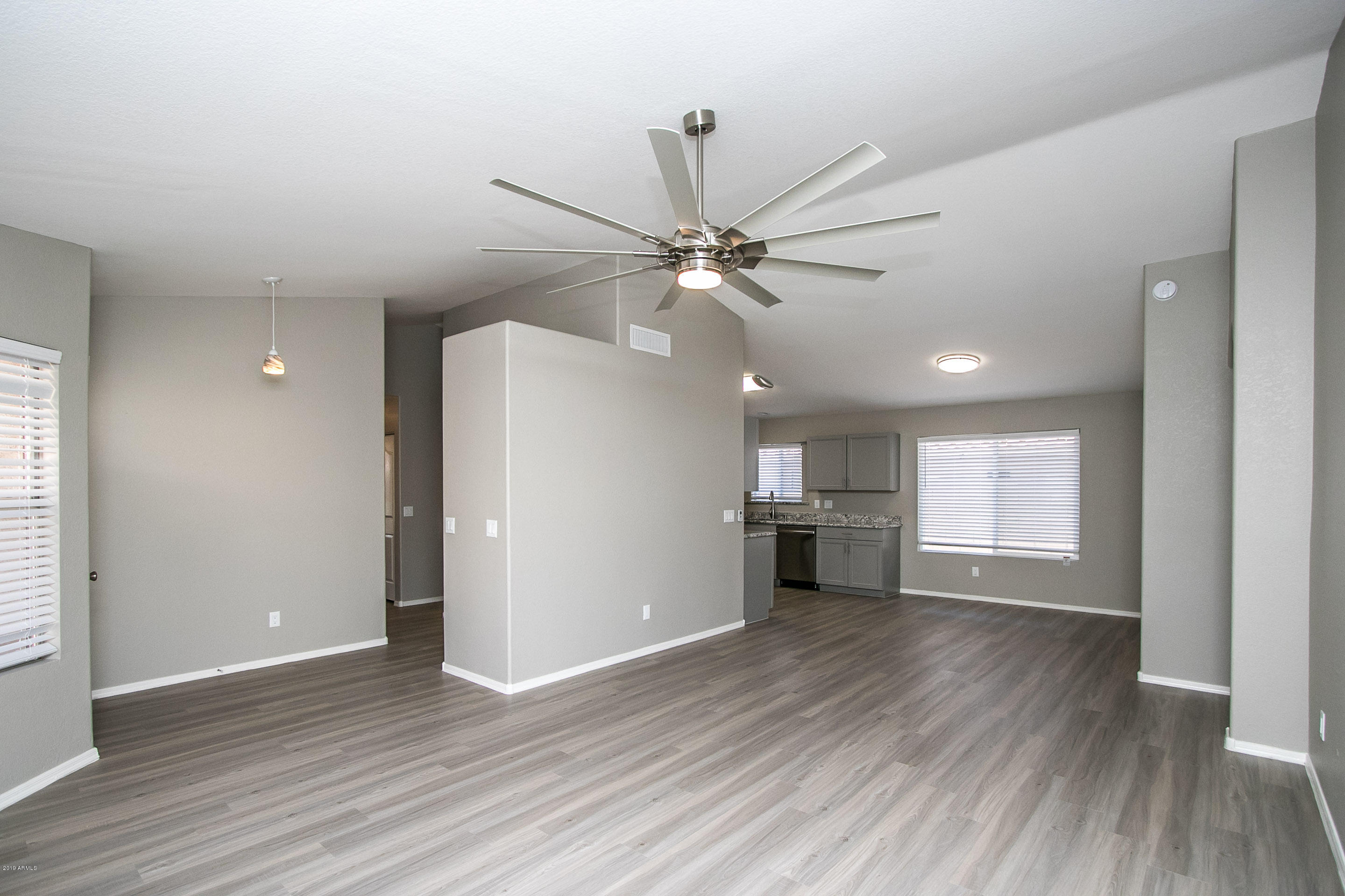 3948 East Stanford Avenue Gilbert, AZ 85234 - Photo 5 of 32 a view of an empty room with a window and wooden floor