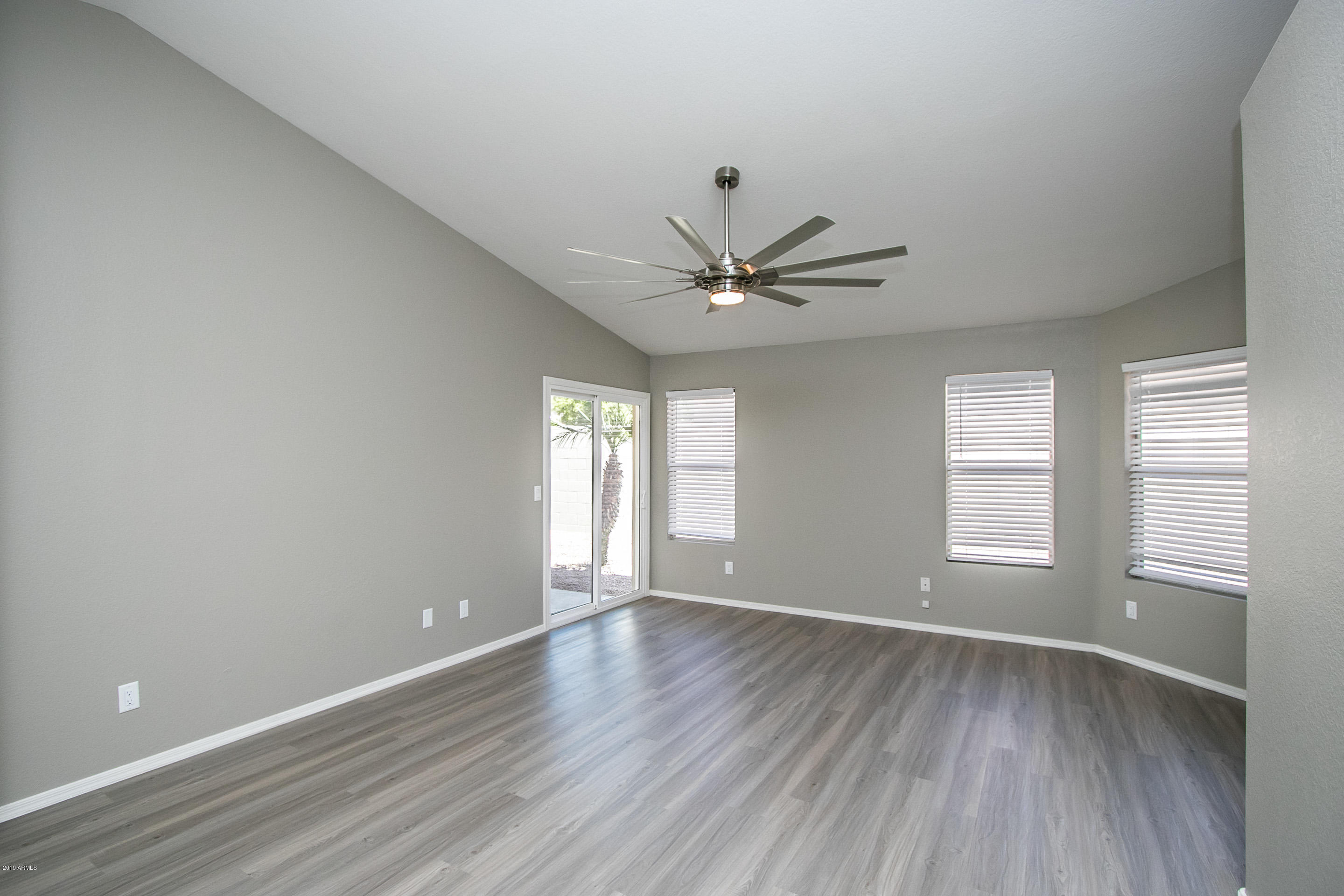 3948 East Stanford Avenue Gilbert, AZ 85234 - Photo 6 of 32 an empty room with wooden floor and windows
