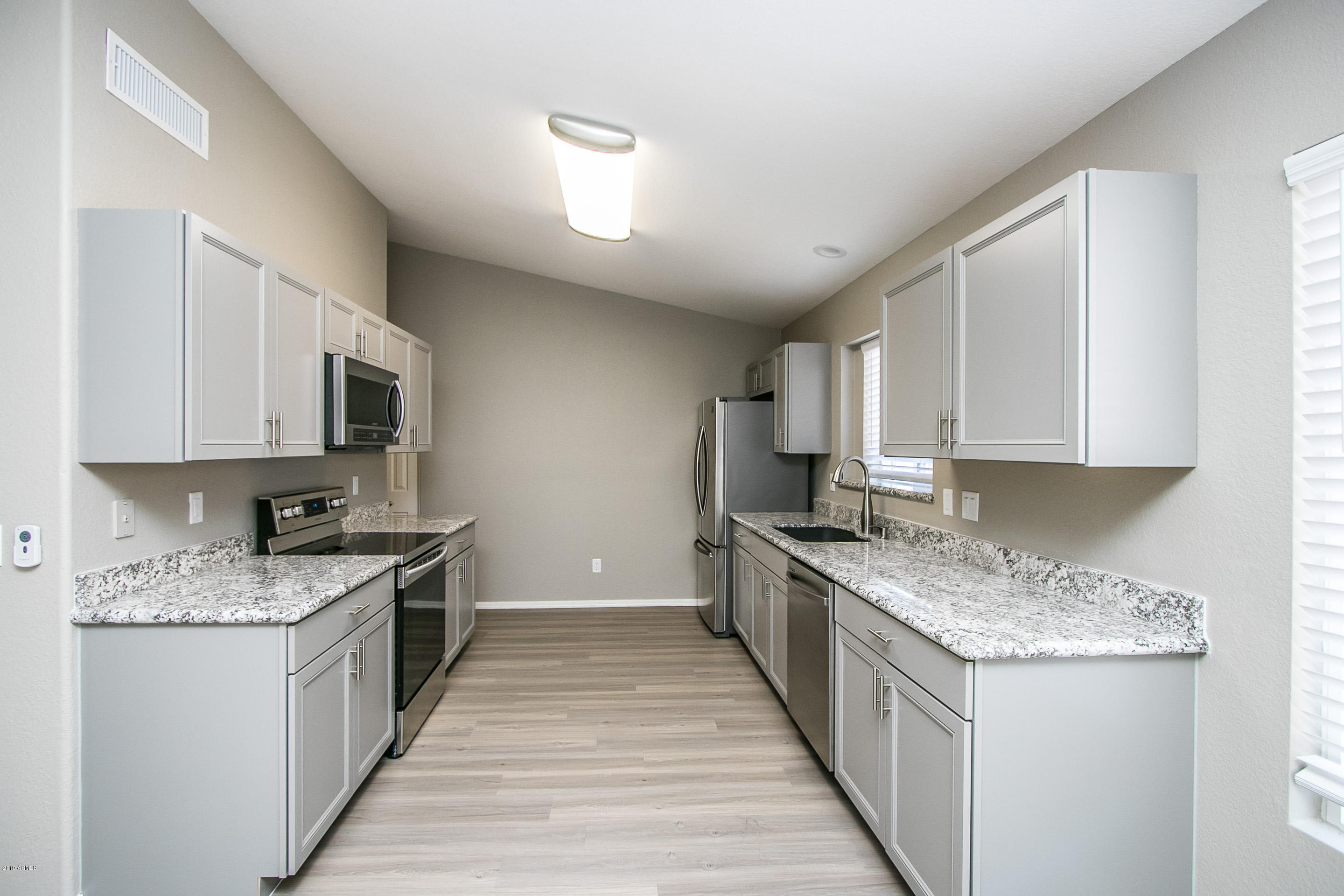 3948 East Stanford Avenue Gilbert, AZ 85234 - Photo 8 of 32 a kitchen with stainless steel appliances granite countertop a stove top oven a sink dishwasher and a microwave oven with cabinets