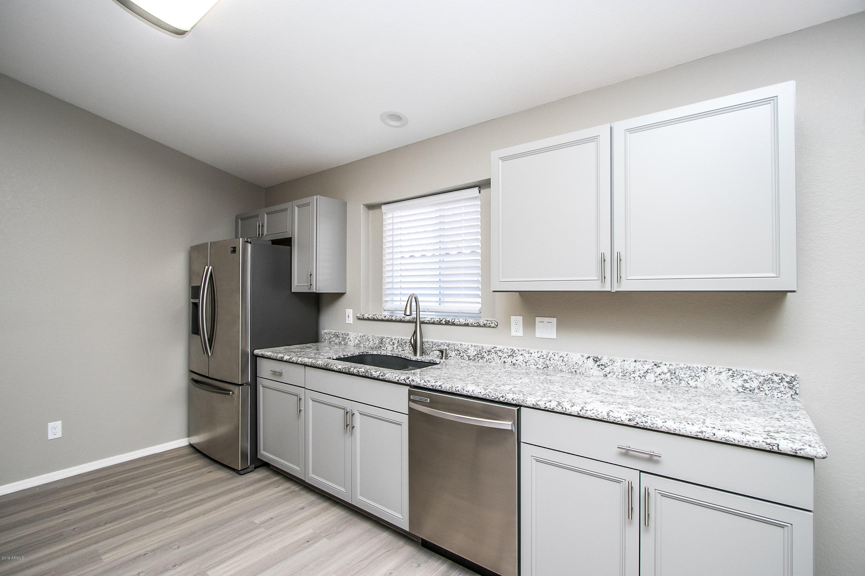 3948 East Stanford Avenue Gilbert, AZ 85234 - Photo 10 of 32 a kitchen with stainless steel appliances granite countertop a sink stove and refrigerator