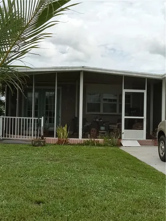 a view of a house with yard and porch