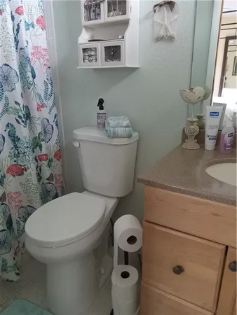 a white toilet sitting next to a bathroom sink