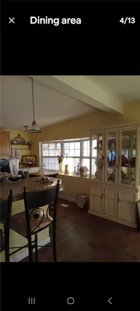 a living room with chairs and a table